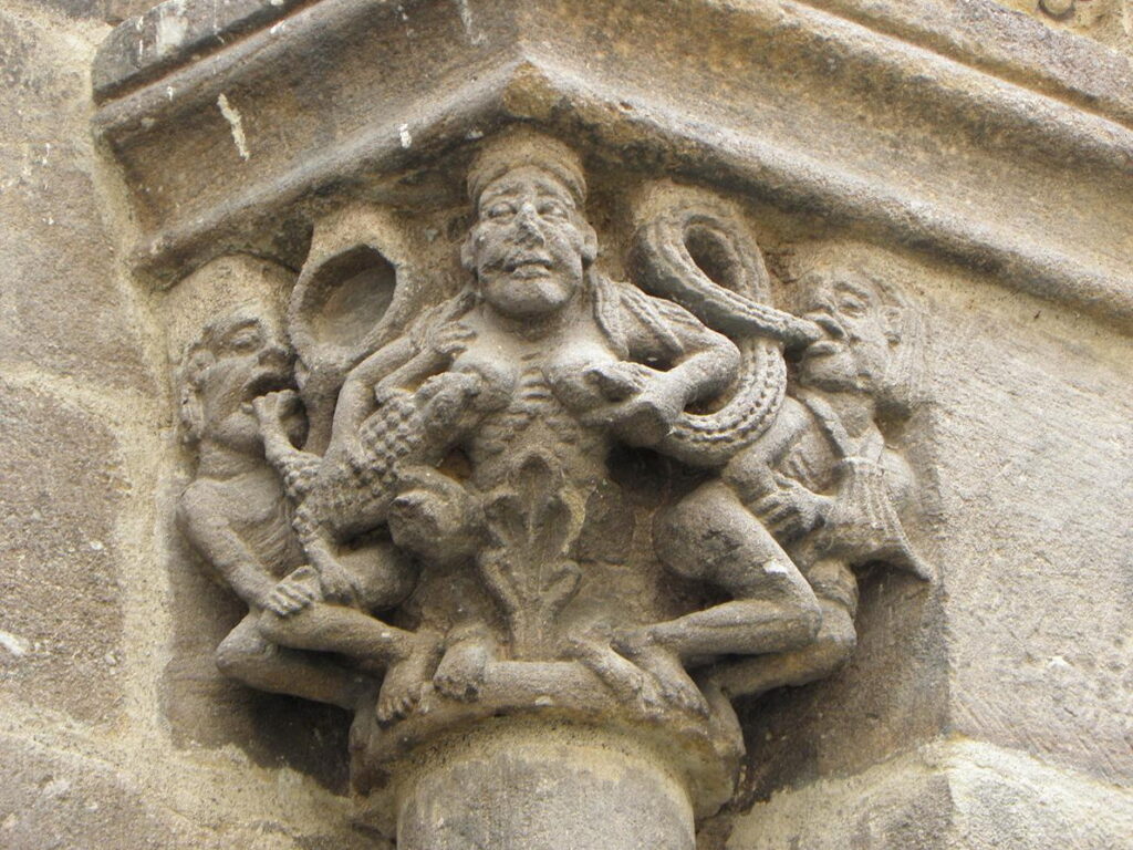 Sculpted capital on the Blesle church representing a woman breastfeeding a snake and a salamander